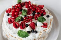 Kaboompics - Close-Up of Berry-Topped Meringue Pavlova with Red Currants and Mint