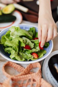 Kaboompics - Adding Cherry Tomatoes to a Bowl of Green Salad