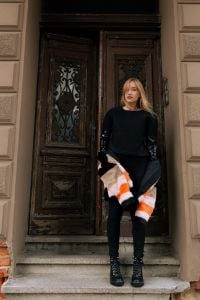 Kaboompics - Full-Body Street Fashion Portrait at an Ornate Historic Door, Black Outfit and Striped Coat