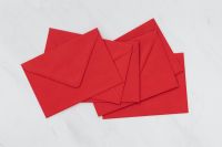 Kaboompics - Scattered Red Envelopes on Marble, Christmas Stationery Flat Lay
