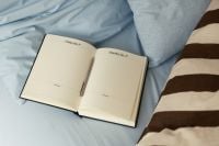 Kaboompics - Open Daily Planner on Soft Blue Bed
