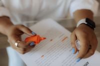 Kaboompics - Close Up of Hands Marking a Printed Agreement