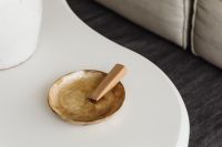 Kaboompics - Close-Up of Palo Santo in a Mother-of-Pearl Bowl on a White Coffee Table