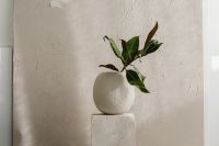 Kaboompics - Green Leaves in Ceramic Vase Against White Textured Wall