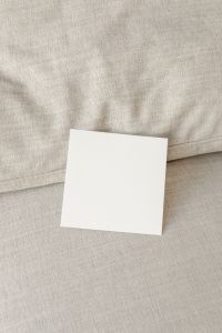 Kaboompics - Square Flyer Mockup Along a Sofa Seam with Copy Space