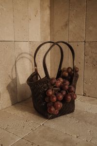 Kaboompics - Red Grapes in Woven Basket against Travertine Wall