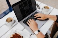 Kaboompics - Hands Typing on a Laptop Beside Coffee and Tiramisu