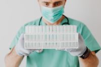 Kaboompics - Masked Doctor Inspecting Laboratory Test Tubes