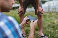 Kaboompics - Closeup of man hands playing videogames on cell phone