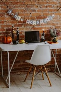 Halloween Home Office Desk With Laptop and Pumpkin Decorations