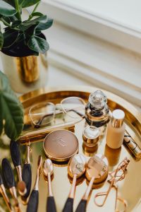 Kaboompics - Makeup essentials on a golden tray