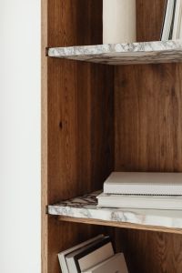 Kaboompics - Close-Up of Marble Bookshelf and Sculptural White Ceramic Vase