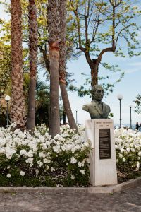 Kaboompics - Side View Of Italian Memorial Bust Surrounded By Palm Trees And Roses