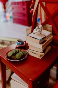 Kaboompics - Coffee, Green Tea Cookies, Books on the Red Chair