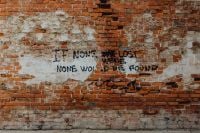 Kaboompics - Graffiti Quote on a Weathered Brick Wall at LX Factory, Lisbon Portugal, Urban Street Art