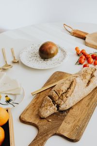 Kaboompics - Bread and Cherry Tomatoes on a Wooden Cutting Board