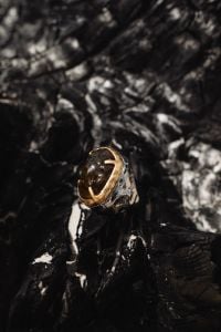 Kaboompics - Gold Ring on a Black Textured Driftwood Surface