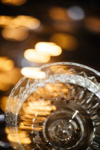 Kaboompics - Champagne Coupe with Golden Star Confetti and Bokeh