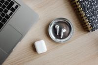 Kaboompics - Top View of Laptop and AirPods with Camera and Notebook
