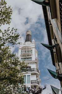 Kaboompics - Madrid Rooftop Tower Framed by a Narrow Street and Leafy Branches