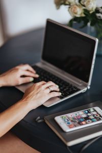 Woman using a laptop by a round breakfast table