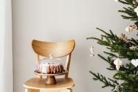 Kaboompics - Iced Bundt Cake on Chair beside Christmas Tree