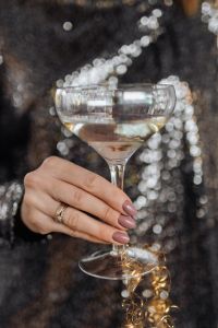 Champagne Celebration Portraits in a Black Sequin Dress with Sparkling Party Lights