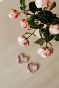 Kaboompics - Pink Roses and Beaded Heart Ornaments on Beige