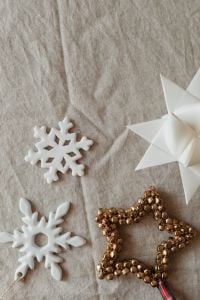 Natural Linen Christmas Flat Lay Backgrounds with White Ornaments and Evergreen Branches
