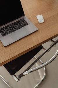Kaboompics - Laptop and Wireless Mouse on Bare Oak Desk with Copy Space