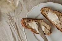 Kaboompics - Sliced Bread With Butter on a Ceramic Plate