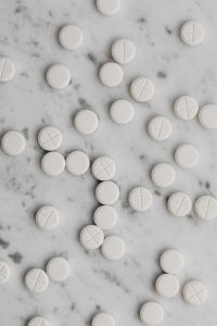 Kaboompics - Scattered White Scored Tablets on Marble
