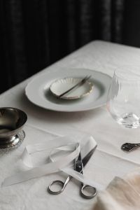 Kaboompics - Close Up White Place Setting with Ribbon and Scissors on Linen Table