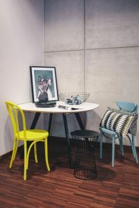 Collection of chairs and tables arranged at a design exhibition