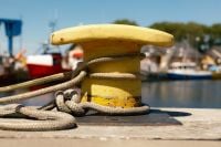 Kaboompics - Yellow Harbor Bollard Wrapped With Mooring Rope