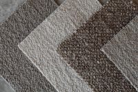 Kaboompics - Geometric Neutral Bouclé Upholstery Fabric Swatches on Gray Stone