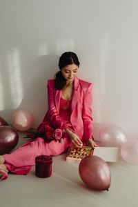 Kaboompics - Woman in Pink Suit Enjoying Valentine Chocolates