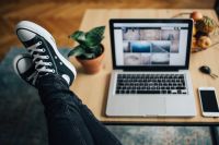 Kaboompics - Black Sneakers Beside Laptop for Casual Work from Home