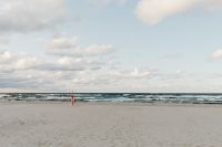 Kaboompics - Cloudy Baltic Sea Horizon with Wide Sandy Shore and Small Red Beach Marker