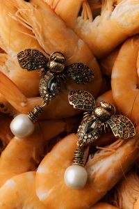 Kaboompics - Elegance Meets Flavor: Shrimp with Vintage Bee Jewelry