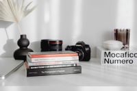 Kaboompics - Photographer's desk - books, DSLR camera and lenses
