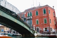 Kaboompics - Green Metal Bridge Crossing a Murano Canal beside a Weathered Red Building