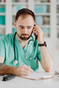 Kaboompics - Doctor Concentrating During Medical Phone Call