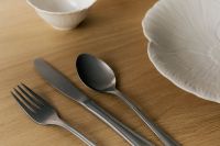 Kaboompics - Close-Up of Silver Fork, Knife and Spoon Beside a White Ceramic Plate on Wood