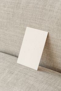 Kaboompics - Vertical Blank Card Mockup Along a Linen Sofa Seam