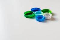Kaboompics - Blue, Green and White Bottle Caps on a White Background