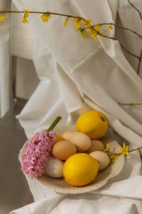 Kaboompics - Easter Still Life with Pastel Eggs, Lemons and Hyacinth on White Linen