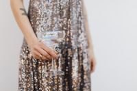 Kaboompics - Champagne Coupe Held in One Hand against a Sequin Dress