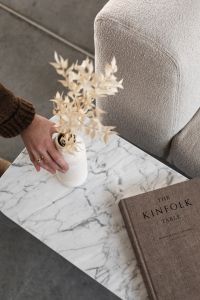 Kaboompics - Hand Styling a Vase on Marble Table Beside Beige Sofa