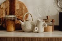 Kaboompics - White Ceramic Teapot, Stacked Cups and Pantry Jars Styled on a Kitchen Counter